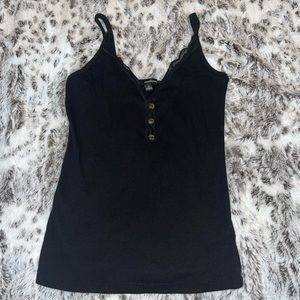 black tank top with brown buttons going down the middle